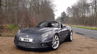 Grey sports car forest road - a road sign free wallpaper