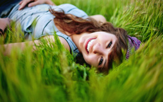 Woman smiling grass blowing wind - the grass free wallpaper