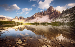 Mountain lake rocks grass cloudy - cloudy free wallpaper