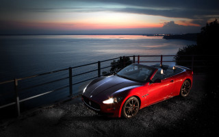 Red sports car ocean night - a road next free wallpaper