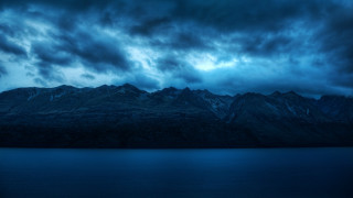 Mountain range dark sky water - a dark sky above free wallpaper