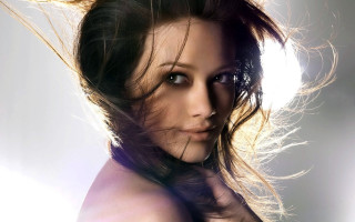 Woman blowing hair photorealistic portrait - the wind free wallpaper