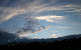 Blue sky clouds clock tower - a building in the distance free wallpaper