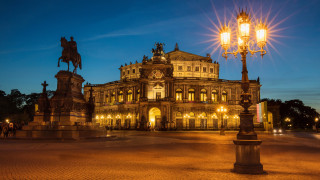 Large building clock night street - the front of it free wallpaper