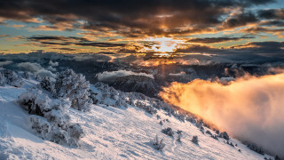 Snowy mountain sun clouds dusk - crepuscular ray free wallpaper