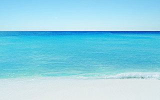 Beach ocean sky sand wave - a clear sky above free wallpaper