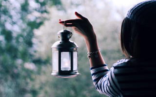 Woman holding lantern outside window - the background and a forest in the background free wallpaper