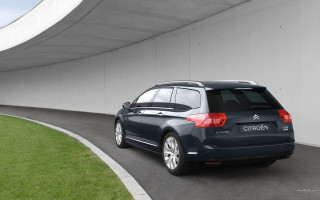 Blue car tunnel road grass - a white wall behind free wallpaper