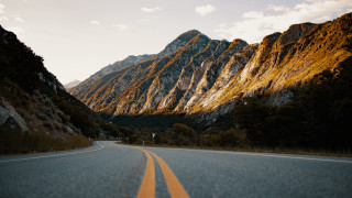 Mountain road cloudy sky sunset - a yellow line free wallpaper