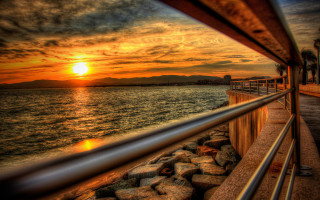 Sunset water pier mountains cinematic - a sunset over a body of water free wallpaper