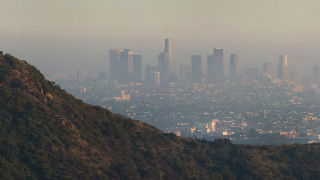 City skyline hill evocative matte - a hazy sky in the background free wallpaper