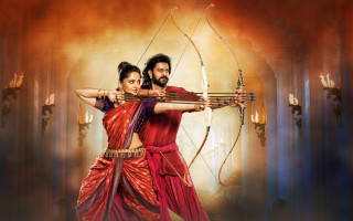 Indian garbed man woman fire - a bow and arrow in front free wallpaper