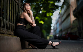 Woman sitting wall black pants - a wall free wallpaper