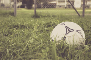 Soccer ball grass fence building - a soccer ball free wallpaper