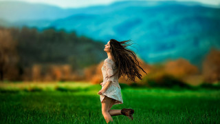 Woman field blowing hair mountains - a woman in a field free wallpaper