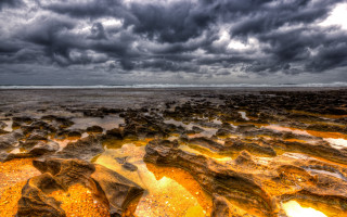 Rocky beach water rocks cloudy - stormy weather free wallpaper