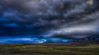 Mountain cloudy sky green field - stormy weather free wallpaper