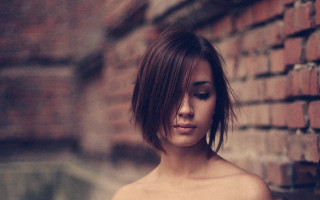 Woman brickwall closedeyes bun hair - figurative art free wallpaper