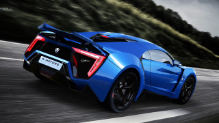 Blue sports car driving forest - a road next free wallpaper