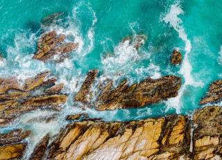Rocky coastline waves crashing ocean - wave free wallpaper