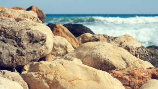 Rocks water waves beach mountains - depth of field free wallpaper