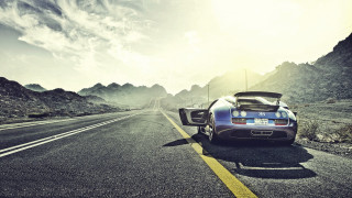 Mountain road sports car cinematic - a mountain range in the background free wallpaper