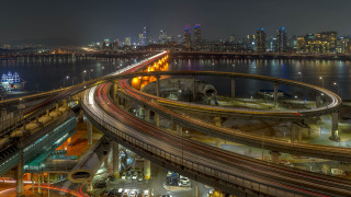 City skyline bridge highway night 2 - a city skyline in the background free wallpaper