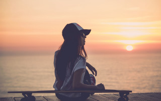 Woman dock skateboard sunset ocean 2 - a skateboard in front free wallpaper