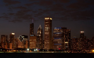 City skyline night lights water 4 - a large body of water in front free wallpaper