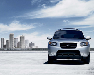 Silver suv cityscape blue sky - a silver suv free wallpaper