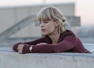 Woman leaning wall blonde portrait - a building in the background free wallpaper