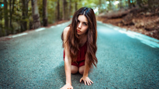 Woman red bodysuit crouching woods - portrait photography free wallpaper for desktop