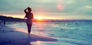 Woman beach sunset reflection lighthouse - the background and the water free wallpaper