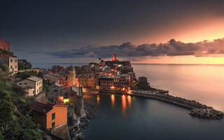 Cliff city ocean mystical night - a body of water below free wallpaper