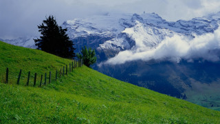Grassy hill fence mountain clouds 2 - a grassy hill free wallpaper