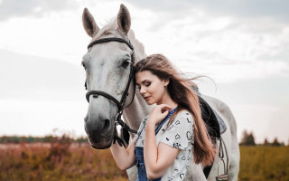 Woman horse field portrait outdoors - a horse in the background free wallpaper