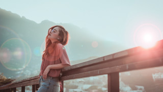 Woman leaning rail blowing hair - a rail free wallpaper