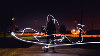 Person lightpainting cyberpunk night outdoors - a sidewalk free wallpaper