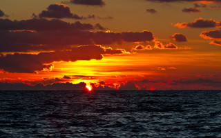 Sunset ocean clouds boat horizon - the water below free wallpaper