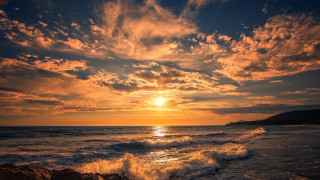 Sunset ocean wave rock person 2 - a sunset over the ocean free wallpaper