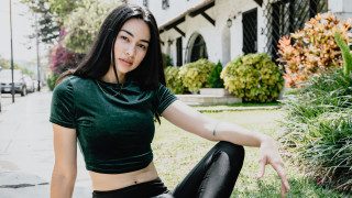 Woman green shirt black pants - her right hand free wallpaper