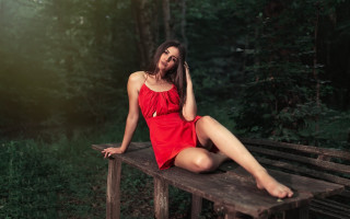 Woman red dress forest sitting - her leg free wallpaper