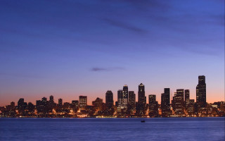 City skyline night boat matte - the water and a boat in the foreground free wallpaper