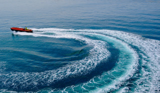 Waves boat island sky sunshine - a boat in the distance free wallpaper