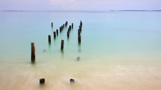 Wooden posts ocean beach sky - long exposure free wallpaper