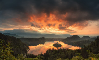 Lake mountains trees sunset cloudy - tree and mountains under a cloudy sky free wallpaper