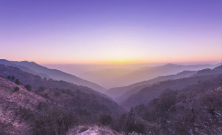 Mountain range sunset trail cloud - a view of a mountain range free wallpaper