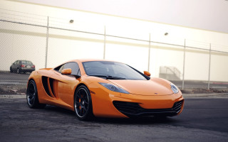 Orange sports car parking lot 2 - a chain link fence free wallpaper