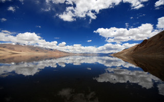 Lake mountain clouds beach boat - a mountain in the distance free wallpaper