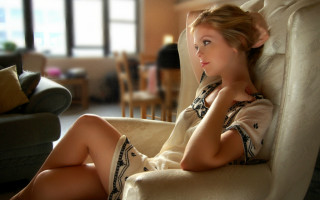 Woman sitting couch livingroom blurry - a couch in a living room free wallpaper